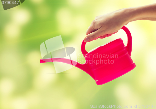 Image of close up of woman hand holding watering can