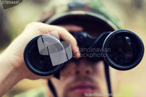 Image of close up of soldier or hunter with binocular