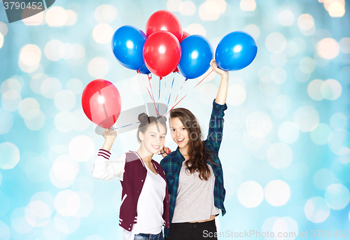 Image of happy teenage girls with helium balloons