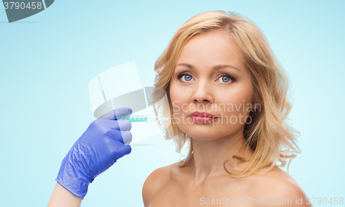 Image of woman face and beautician hand with syringe