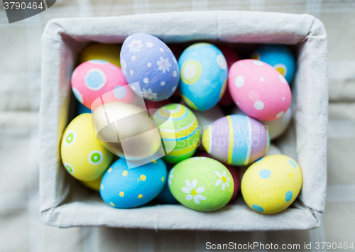 Image of close up of colored easter eggs in basket