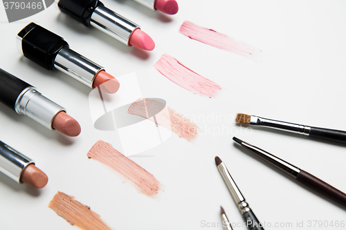 Image of close up of lipsticks range with makeup brushes