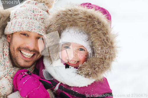 Image of happy family in winter clothes outdoors