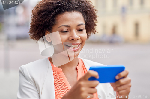 Image of happy african businesswoman with smartphone