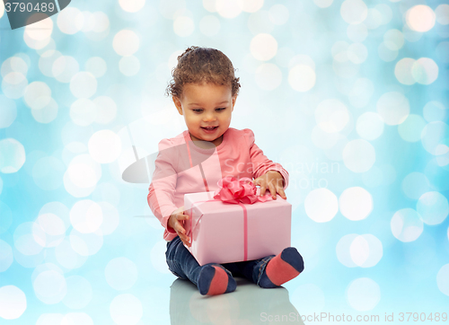 Image of happy little baby girl with birthday present