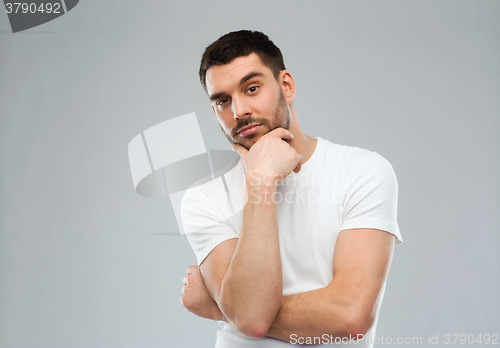 Image of man thinking over gray background