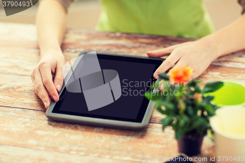 Image of close up of woman or gardener with tablet pc