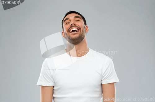 Image of laughing man over gray background