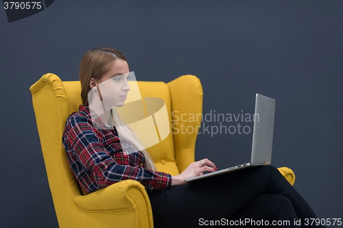 Image of startup business, woman  working on laptop and sitting on yellow