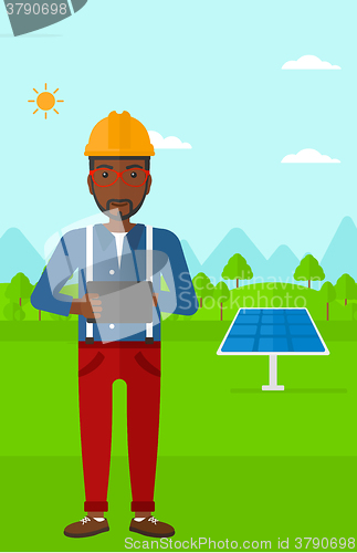 Image of Man holding tablet computer.