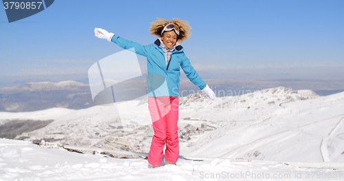 Image of Happy adult in ski clothes waving arms