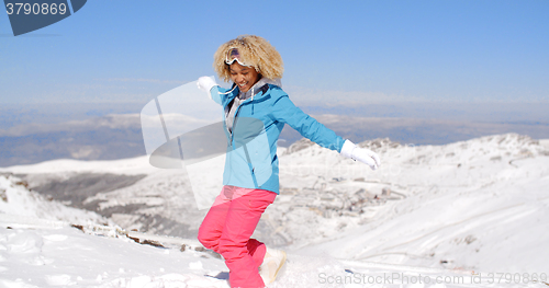 Image of Happy adult in ski clothes waving arms