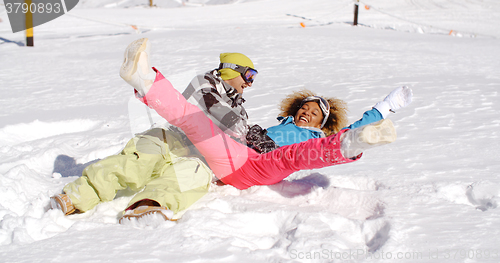 Image of Young couple enjoying a frolic in the snow