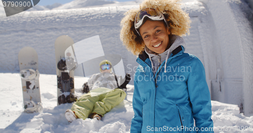 Image of Cute skier front of friend in snow