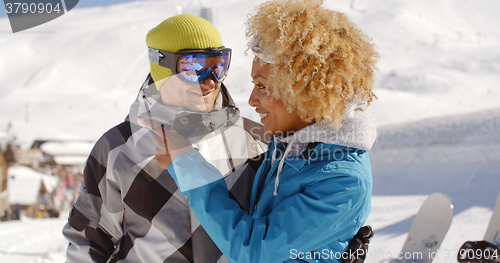 Image of Adult woman looking at friend near snowboards