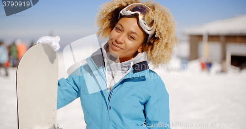 Image of Gorgeous trendy young woman with her snowboard