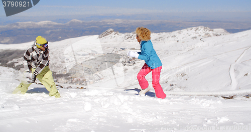 Image of Young couple having fun playing in the snow