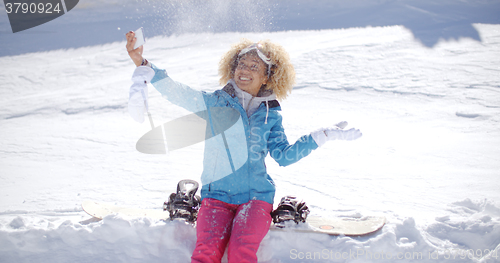 Image of Playful woman posing for a selfie in the snow