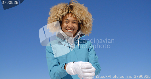 Image of Cute woman in frizzy hair and winter coat