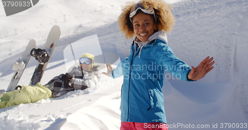 Image of Successful female skier next to man in snow