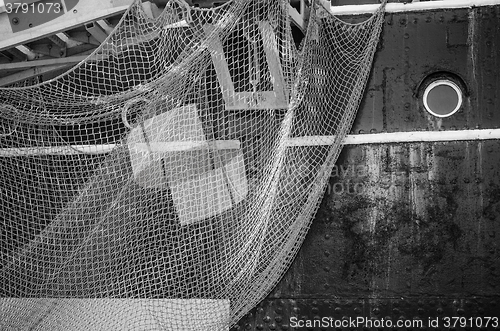 Image of Window of the ship and hanging down networks, close up