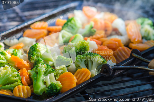 Image of Vegetables fried on coals, close up. Note: Shallow depth of fiel