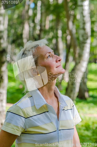 Image of Portrait of the woman in a birch wood