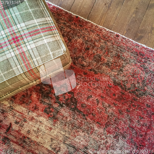 Image of Checked textile hassock and vintage style carpet