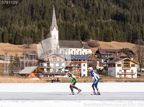 Image of Two people skating on the ice