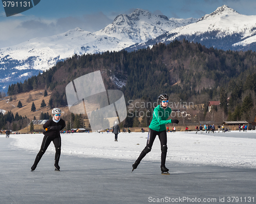 Image of Two people skating on the ice
