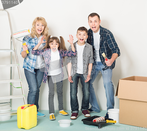 Image of Happy family makes repairs at home