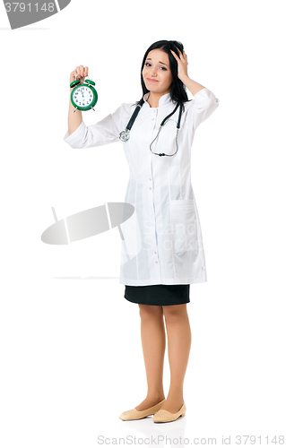 Image of Young female doctor with clock