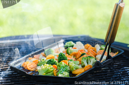 Image of Vegetables fried on coals, close up. Note: Shallow depth of fiel