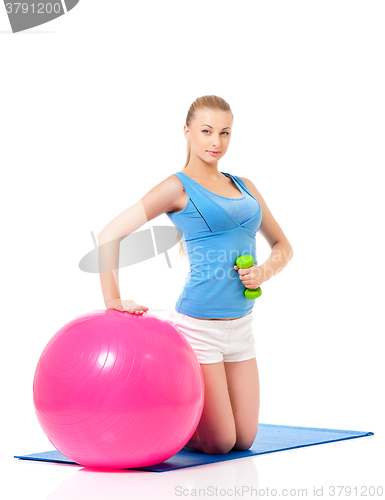 Image of Woman in fitness wear exercising with fitness-ball
