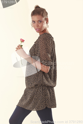 Image of Trendy girl with rose in hand