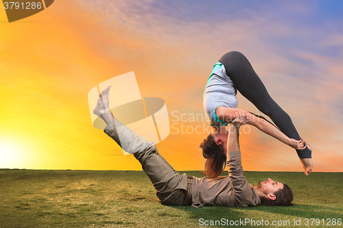 Image of The two people doing yoga exercises 