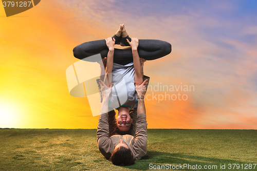 Image of The two people doing yoga exercises 