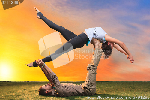 Image of The two people doing yoga exercises 