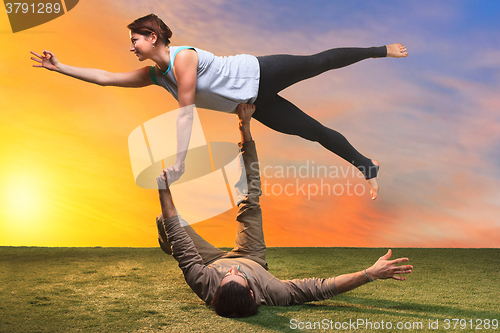 Image of The two people doing yoga exercises 