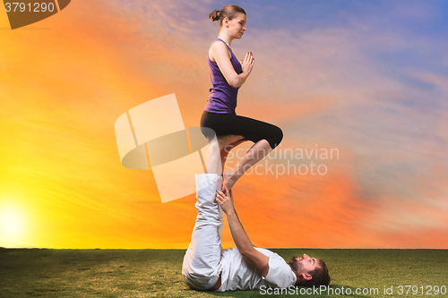 Image of The two people doing yoga exercises 