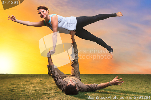 Image of The two people doing yoga exercises 