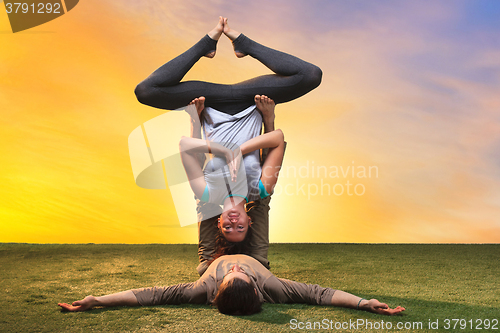 Image of The two people doing yoga exercises 