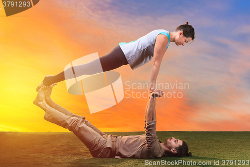 Image of The two people doing yoga exercises 