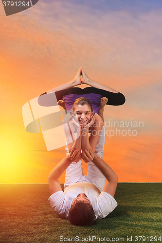 Image of The two people doing yoga exercises 