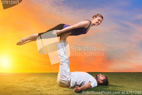 Image of The two people doing yoga exercises 