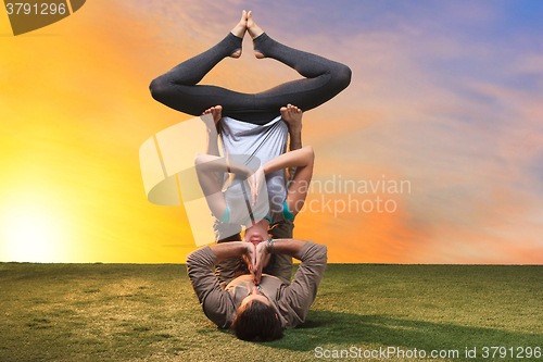 Image of The two people doing yoga exercises 