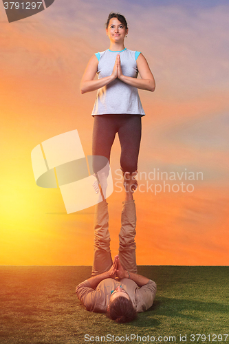 Image of The two people doing yoga exercises 