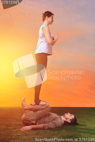 Image of The two people doing yoga exercises 