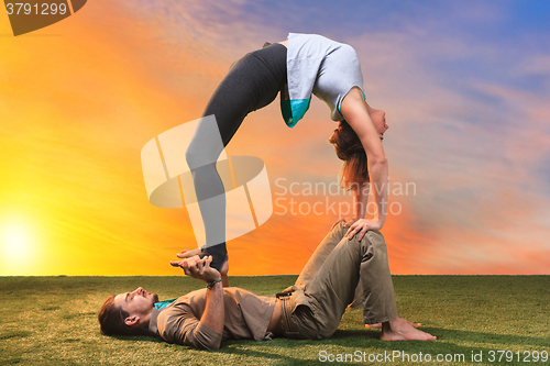 Image of The two people doing yoga exercises 