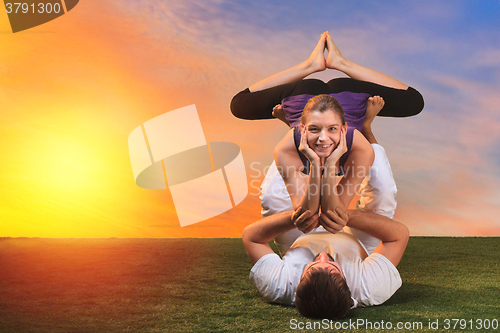 Image of The two people doing yoga exercises 